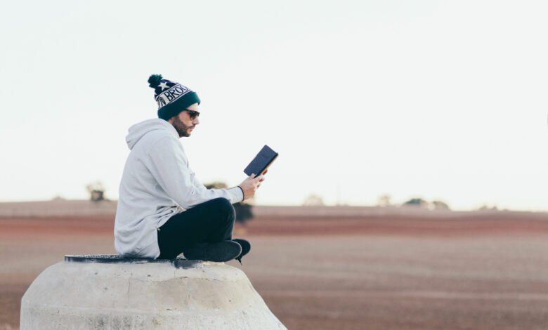 a guy sitting and using internet on his laptop